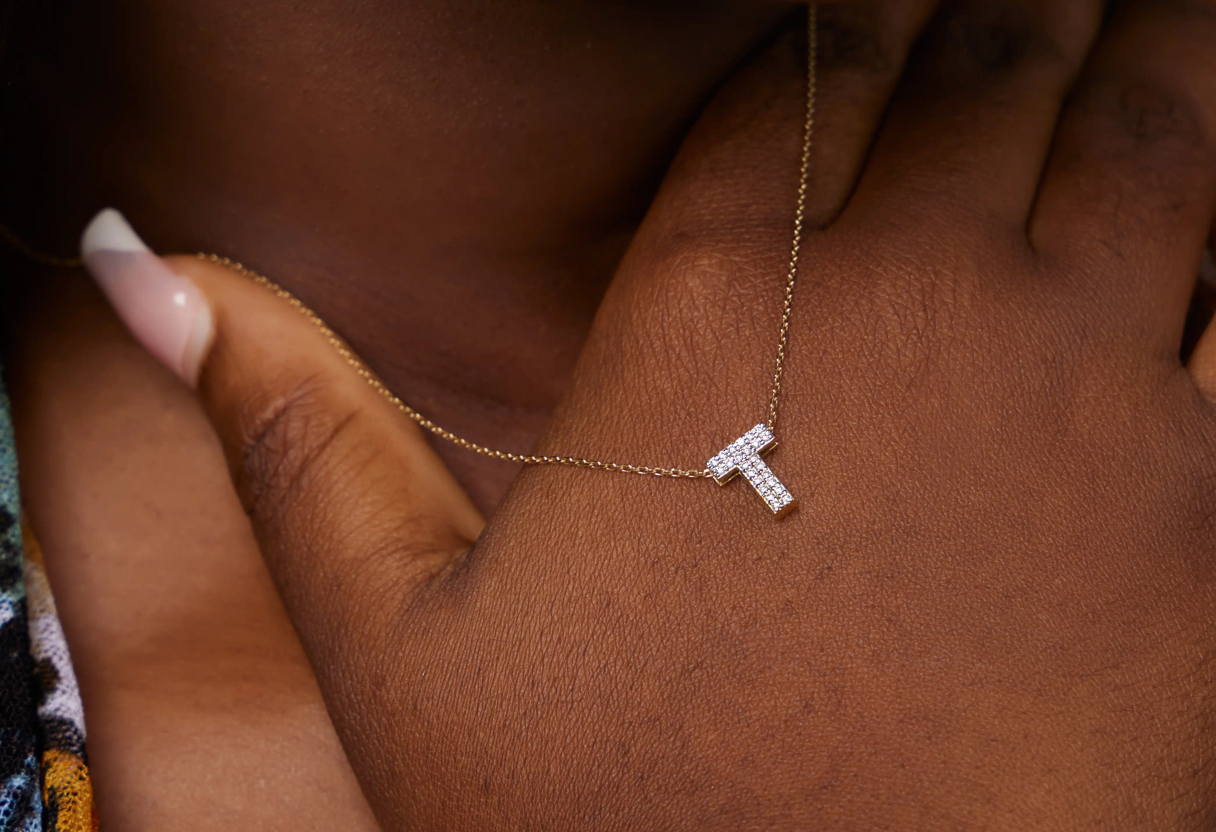 Lady wearing a t-shaped white gold pendant