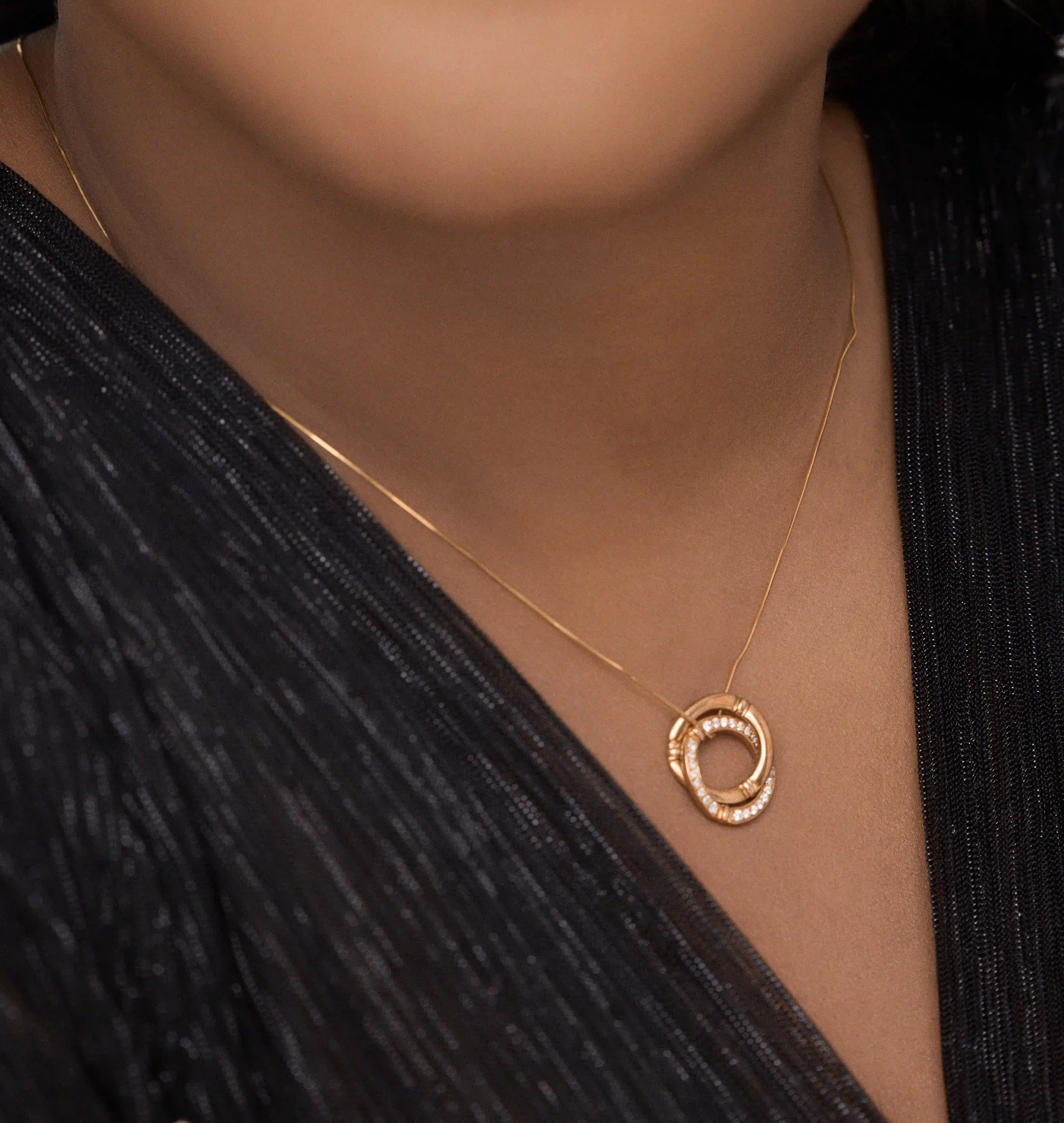 Detail shot of 18k gold bamboo pendant showing the natural bamboo texture