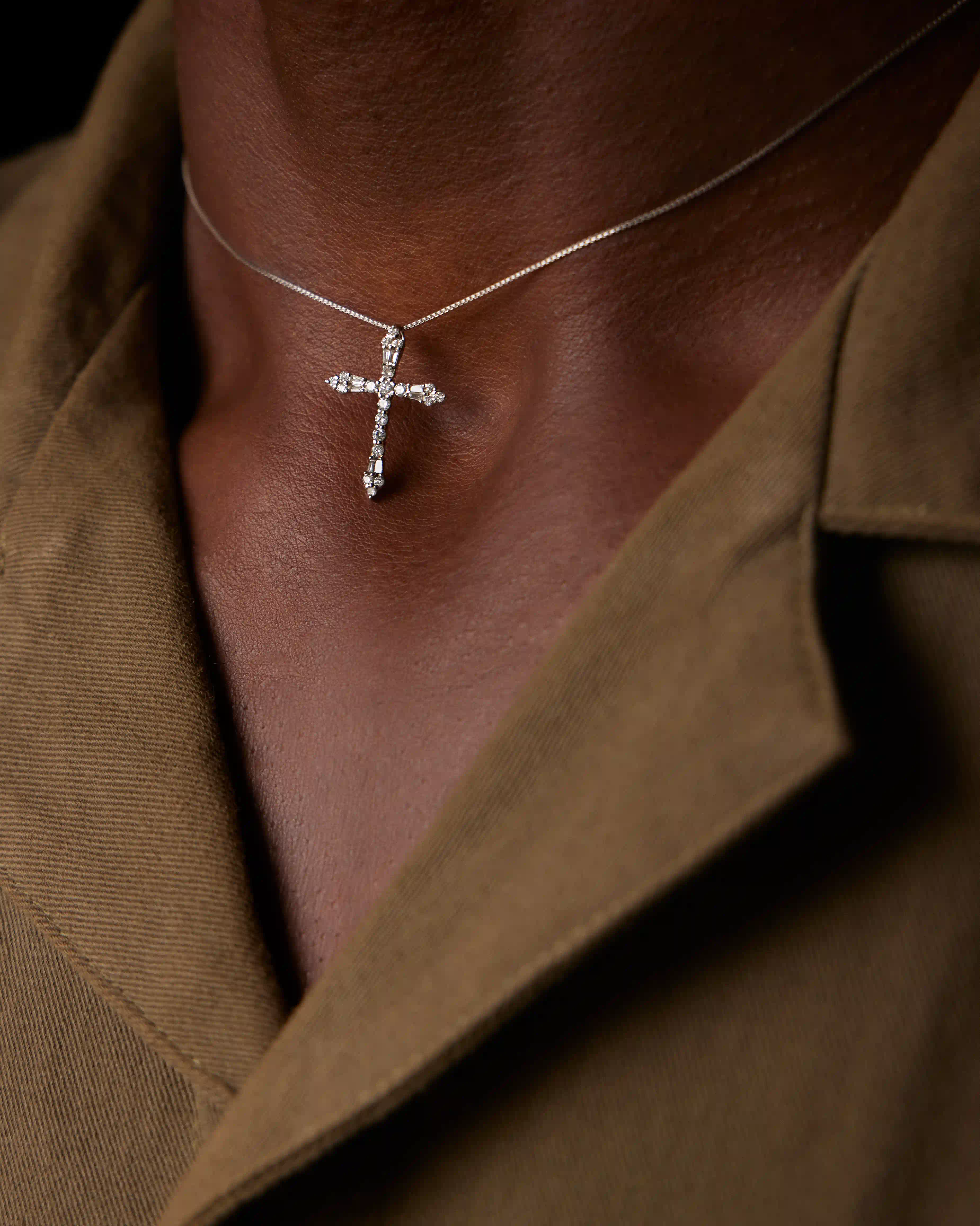 Macro shot highlighting the craftsmanship of the diamond-set cross pendant