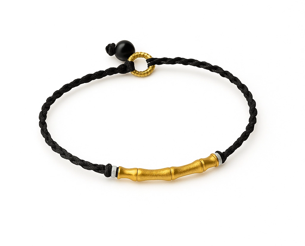 Detailed view of adjustable black bamboo bracelet with gold detailing