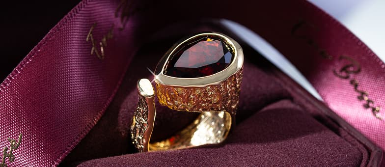 Ruby ring with gold metal in a box.